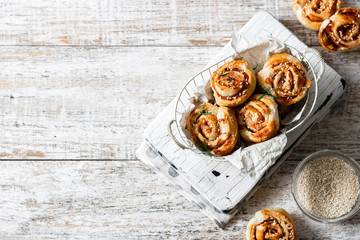 Unsweetened snails and puff pastry with bacon, sesame seeds and rosemary.