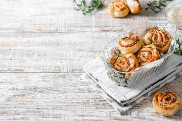 Unsweetened snails and puff pastry with bacon, sesame seeds and rosemary.