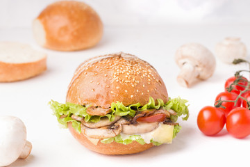 vegetarian mushroom sandwich close-up on a white plate next to the ingredients.