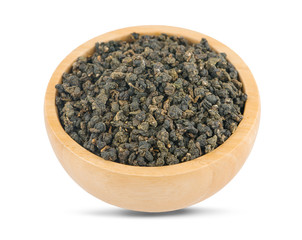 Dry green oolong tea in wooden bowl an isolated on white background