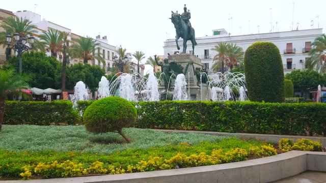 JEREZ, SPAIN - SEPTEMBER 20, 2019: The beautiful fountain and topiary garden surround equestrian statue of Miguel Primo de Rivera, situated in Plaza del Arenal, on September 20 in Jerez
