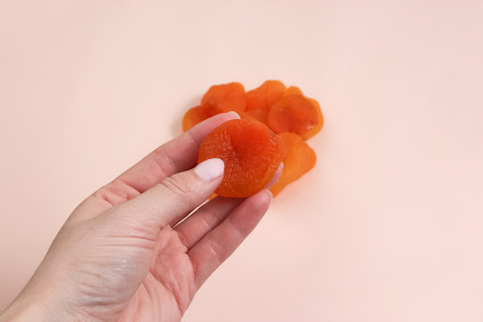 Handful Of Dried Apricots. Woman Holding Dried Apricots.