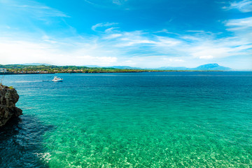 Sailing boat, serene ocean view with transparent crystalline turquoise water