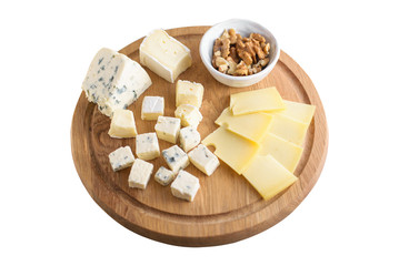 Delicious cheese plate with cheeses Dorblu, Brie, Camembert, nuts. Serving on a wooden round board. Healthy snack or aperitif for white or red wine. Selective focus, on white isolate background