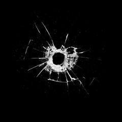 glass with a hole and cracks isolated on a black background