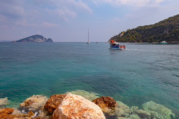 A pleasure boat takes tourists to the island of Tserepakh near the Greek island of Zakynthos