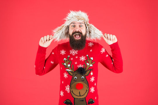 Feel Joy About Holidays. Wear Warm Earflap Hat In Cold Season. Hipster With Beard In Favorite Sweater. Knitwear And Fur Accessory. Completely Happy In New Year. Merry Christmas. Male Winter Fashion