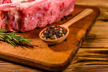 Raw pork ribs with spices and rosemary on a cutting board