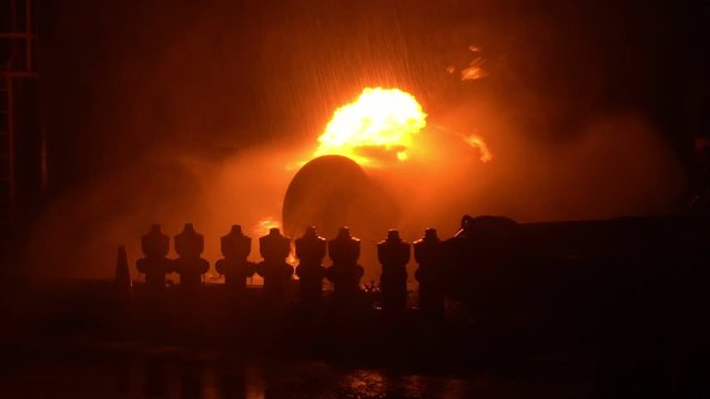 Fireman training Spray water curtain , group of firefighters helped stop the fire. Fire in the Industrial Factory . Rescue ,Education ,Emergency and Teamwork concept .