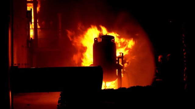 Fireman training Spray water curtain , group of firefighters helped stop the fire. Fire in the Industrial Factory . Rescue ,Education ,Emergency and Teamwork concept .
