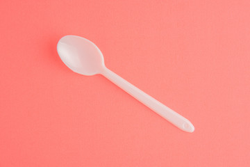 Plastic Spoon Isolated On Pink Background, White Plastic Spoon