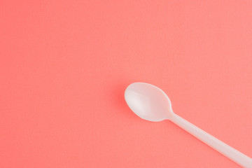 Plastic Spoon Isolated On Pink Background, White Plastic Spoon