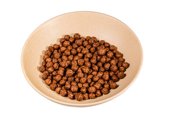 Ceramic plate with chocolate cereal balls isolated on a white background
