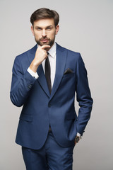 Studuo shot of thinking businessman wearing suit