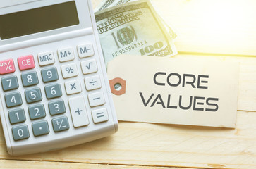 CORE VALUES Words on tag with dollar note and calculator on wood backgroud,Finance Concept