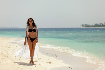 Fototapeta na wymiar Happy beautiful woman on the beach on tropical ocean coast.
