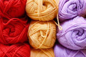 background of rows skeins of fluffy wool yarn for knitting different bright colors