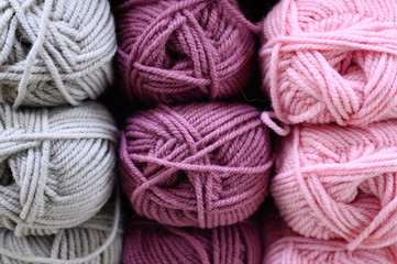 background of rows skeins of fluffy wool yarn for knitting different bright colors