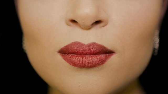 The girl makes an air kiss with her lips