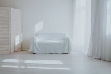 the Interior of the white room with sofa and window