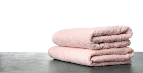 Folded fresh clean towels for bathroom on table against white background. Space for text
