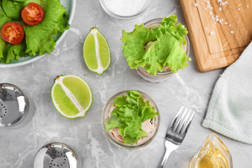 Healthy salad in glass jars on marble table, flat lay