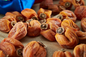 Dried persimmon fruit on silk textile 