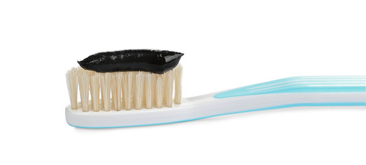 Natural bristle toothbrush with charcoal paste isolated on white