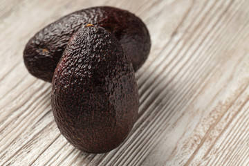 Avocado - dark hass avocado on wooden board