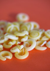 Close up view on selection of authentic Italian messicani pasta on red surface