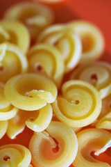 Close up view on selection of authentic Italian messicani pasta on red surface