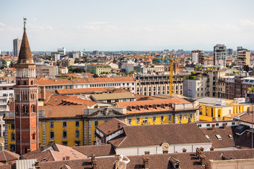 Fototapeta na wymiar Aerial view of the old downtown of the Milan City with beautiful rooftops, view from the top of cathedral church of Milan, Lombardy, Italy.