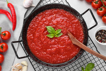Delicious tomato sauce in pan on table, flat lay