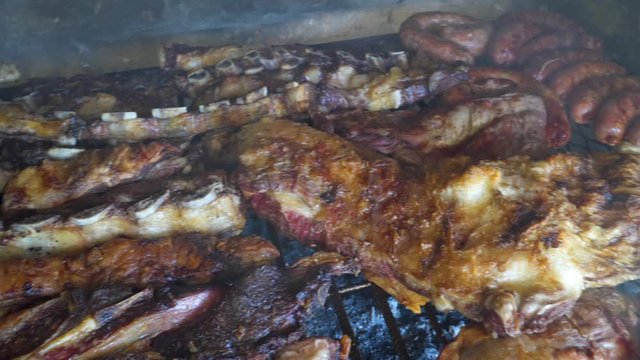 Ribs, beef, chicken and chorizos being roasted in traditional Argentinian asado