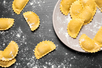 Ravioli on grey wooden table, flat lay. Italian pasta