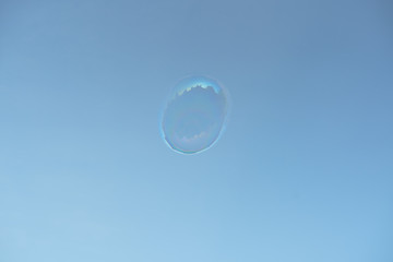 one alone transparent soap bubble on blue sky minimal 