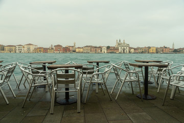 view of Venice from Giudecca with tables and chairs