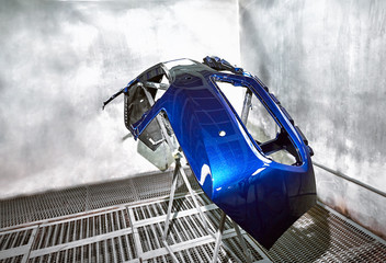 Preparation and painting of car parts after an accident.