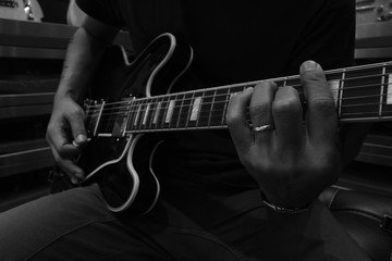 young musician playing Electric Guitar, black and white, play the music, with selective focus