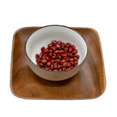 Wooden rectangular plate and ceramic bowl with red beans standing on it. Isolate on white background. Front view and from above.