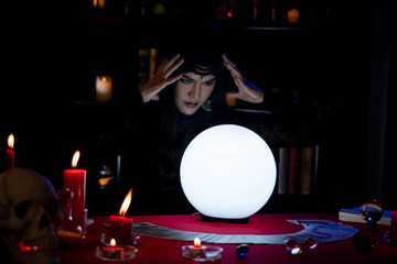Fortune Teller young Asian woman Gypsy glowing crystal ball, tarot cards, magic, and composition...