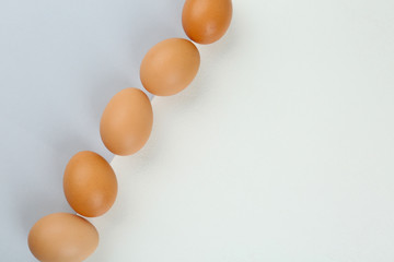 Raw chicken eggs on color background, flat lay. Space for text