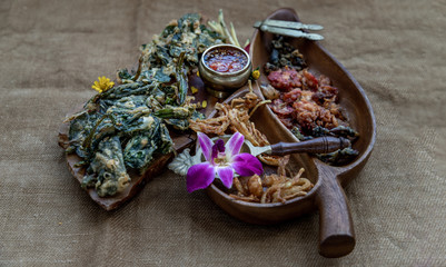 Crispy Flowers, Crispy Herbs and Crispy Vegetables served  with Sweet sauce in a Wooden tray.