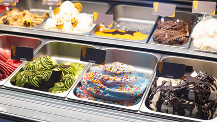 Selling delicious fresh ice cream by weight in a shop window, background