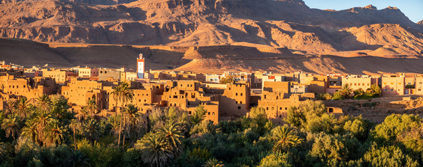 Obraz premium Morocco, traditional clay brick buildings mix perfectly with modern constructions in Tinehir