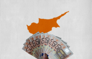 Cyprus flag with Euro banknotes in the hand