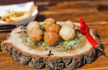 cheese balls on a wooden plate