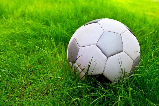 Soccer ball on the field in the grass. Close-up. Lifestyle.