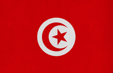 National flag of Tunisia on a cotton texture background