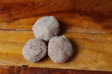 Close-up of coconut rava ladoos on wood background in india
